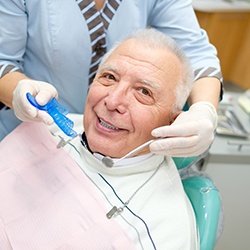 A smiling senior man receiving dental care