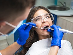 Dentist smiling at patient's dental exam