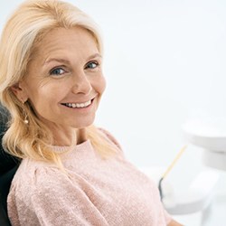 a patient smiling after receiving dental implants