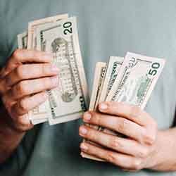 Close up of man’s hands counting cash