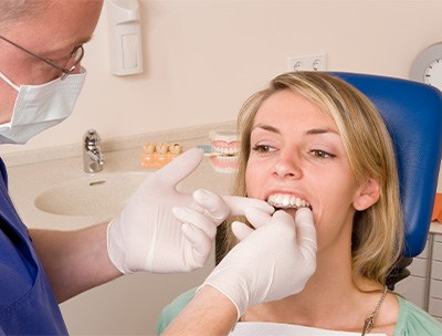 Invisalign patient in Toledo smiling at dentist